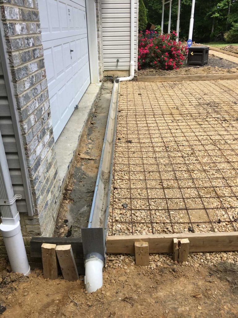 french drain and concrete driveway installation